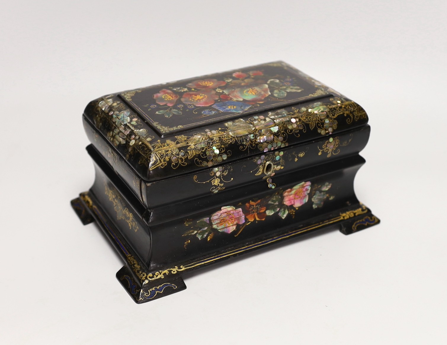 A Victorian painted and mother of pearl inlaid papier mache tea caddy. 23cm wide